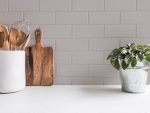 Stylish,White,Kitchen,Background,With,Kitchen,Utensils,And,Green,Houseplant
